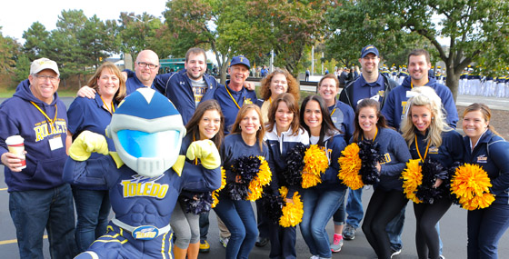 Members of the Cheerleading Alumni Affiliate with Rocky at Homecoming