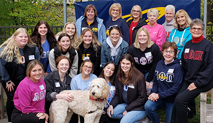 A group photo of Alpha Omicron Pi sorority members and their alumni