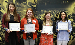 UToledo students standing in a line holding certificates
