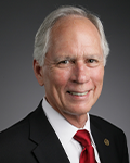 Headshot photo of Lee Johnson smiling at camera