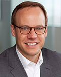 Headshot photo of Brad Windbigler smiling at camera