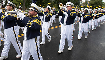 UToledo marching band walking and performing on Bancroft street during the homecoming parade