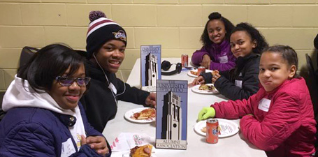 Alumni members with their children at an event