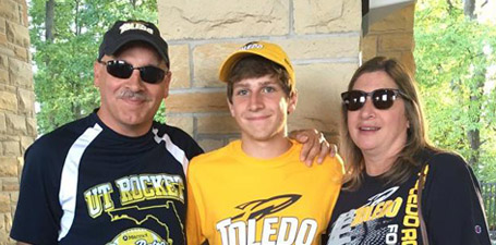 Mom and dad with their son at a pregame party